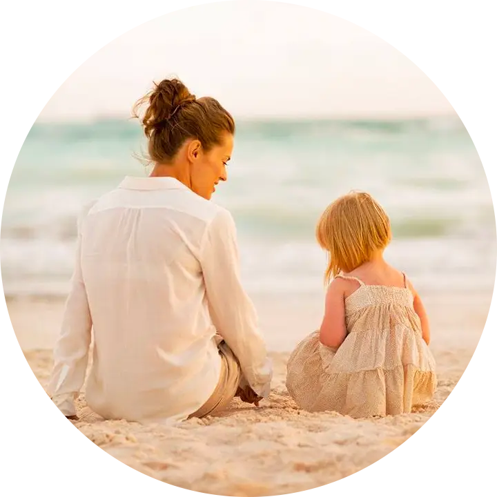 Stock photo- woman and her child sitting on the beach