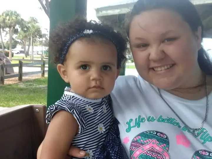 A babysitter from The Super Sitters FL siting with a child